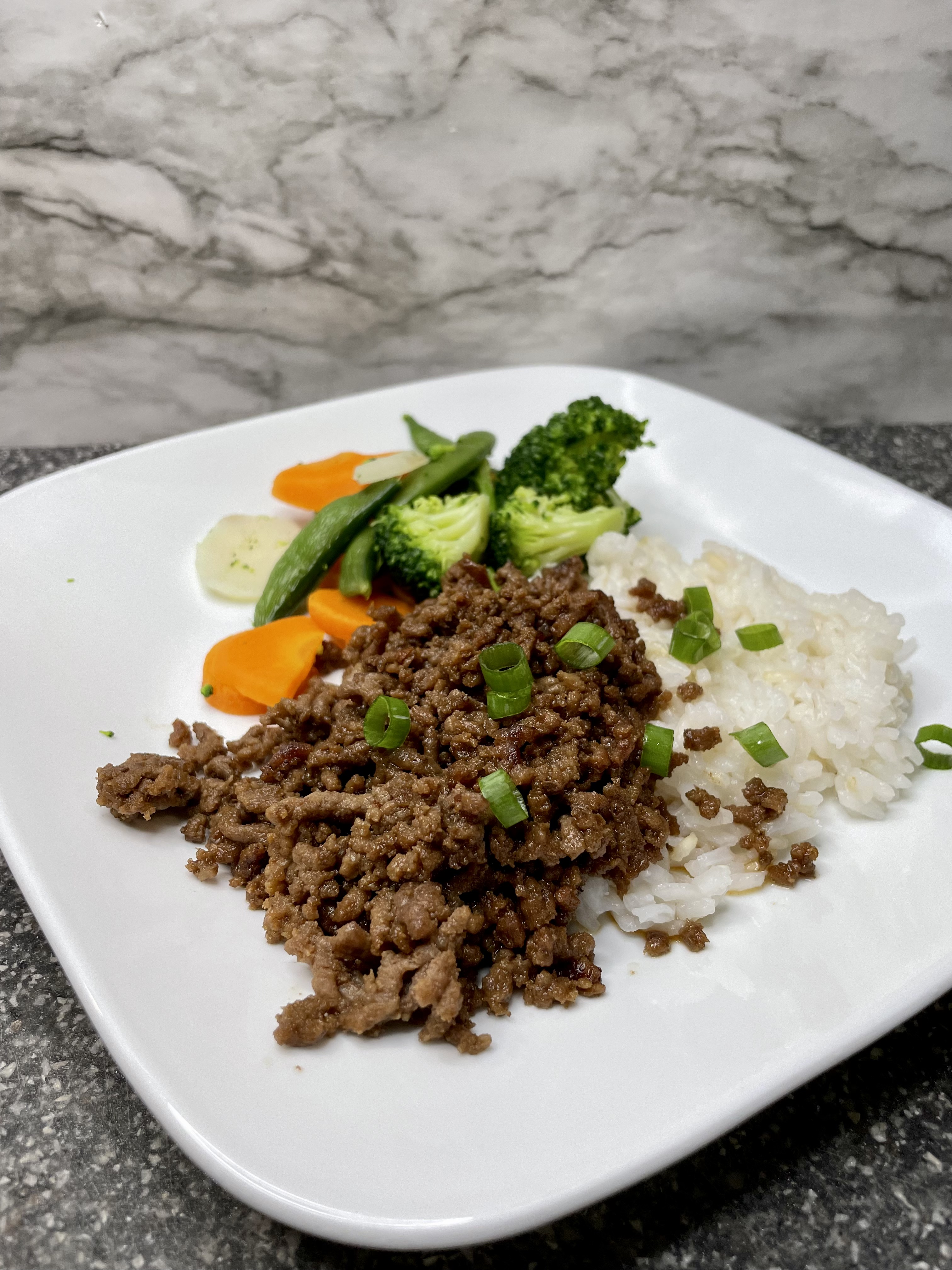 A plate of easy Korean ground beef served over rice with green onions and sesame seeds – a quick and flavorful weeknight dinner.